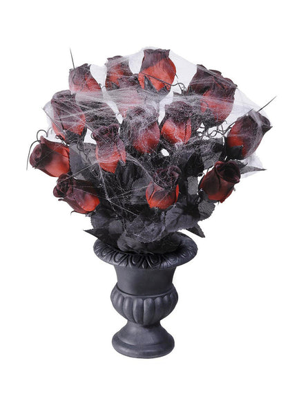 Vase avec roses rouges et toile d'araignée