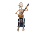 squelette assis avec banjo motorisé sonore et lumineux 90cm